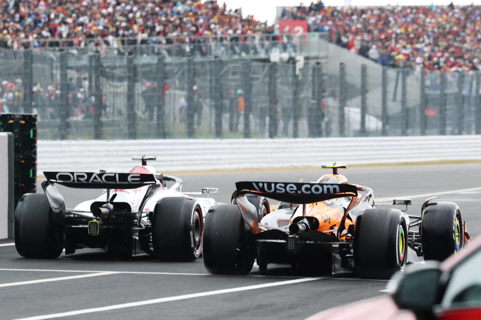 SUZUKA, JAPAN - APRIL 06: Max Verstappen of the Netherlands driving the (1) Oracle Red Bull Racing RB21 and Lando Norris of Great Britain driving the (4) McLaren MCL39 Mercedes battle for track position as they leave the Pitlane during the F1 Grand Prix of Japan at Suzuka Circuit on April 06, 2025 in Suzuka, Japan. (Photo by Steven Tee/LAT Images)