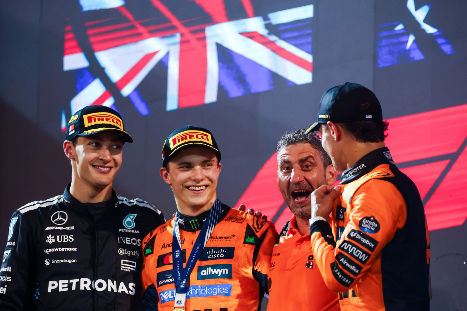 BAHRAIN, BAHRAIN - APRIL 13: Race winner Oscar Piastri of Australia and McLaren Second placed George Russell of Great Britain and Mercedes AMG Petronas F1 Team Third placed Lando Norris of Great Britain and McLaren and Andrea Stella, Team Principal of McLaren on the podium during the F1 Grand Prix of Bahrain at Bahrain International Circuit on April 13, 2025 in Bahrain, Bahrain. (Photo by Peter Fox/LAT Images)
