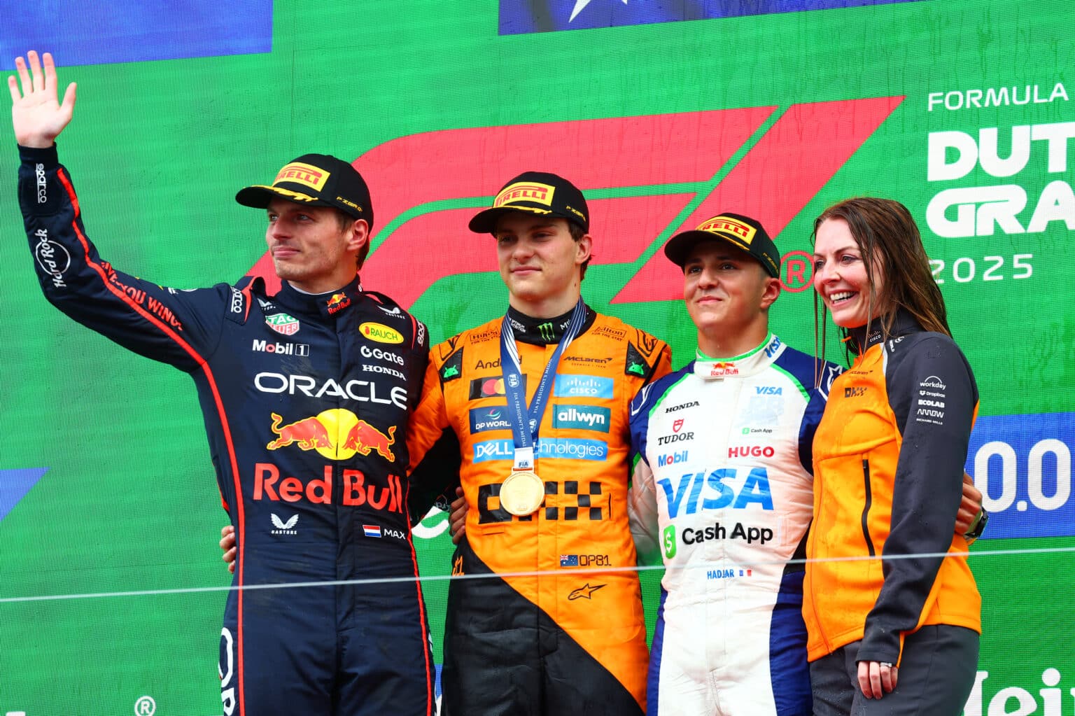 ZANDVOORT, NETHERLANDS - AUGUST 31: Race winner Oscar Piastri of Australia and McLaren Second placed Max Verstappen of the Netherlands and Oracle Red Bull Racing Third placed Isack Hadjar of France and Visa Cash App Racing Bulls and Laura Bowden, Chief Financial Officer at McLaren celebrate on the podium during the F1 Grand Prix of Netherlands at Circuit Zandvoort on August 31, 2025 in Zandvoort, Netherlands. (Photo by Joe Portlock/Getty Images)