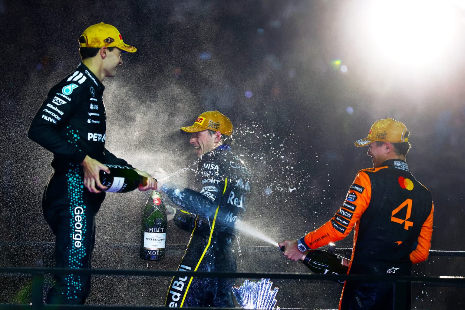 LAS VEGAS, NEVADA - NOVEMBER 22: Race winner Max Verstappen of the Netherlands and Oracle Red Bull Racing Second placed Lando Norris of Great Britain and McLaren and Third placed George Russell of Great Britain and Mercedes AMG Petronas F1 Team celebrate on the podium with Champagne during the F1 Grand Prix of Las Vegas at Las Vegas Strip Circuit on November 22, 2025 in Las Vegas, Nevada. (Photo by Mark Thompson/Getty Images) // Getty Images / Red Bull Content Pool // SI202511230570 // Usage for editorial use only //